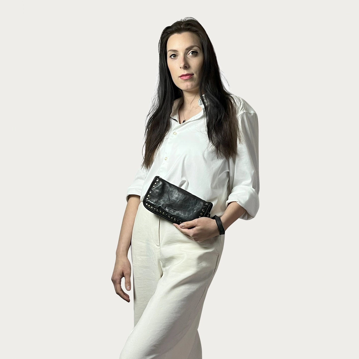 Black Italian leather wallet — Aurum style — carried by model — Made in Tuscany