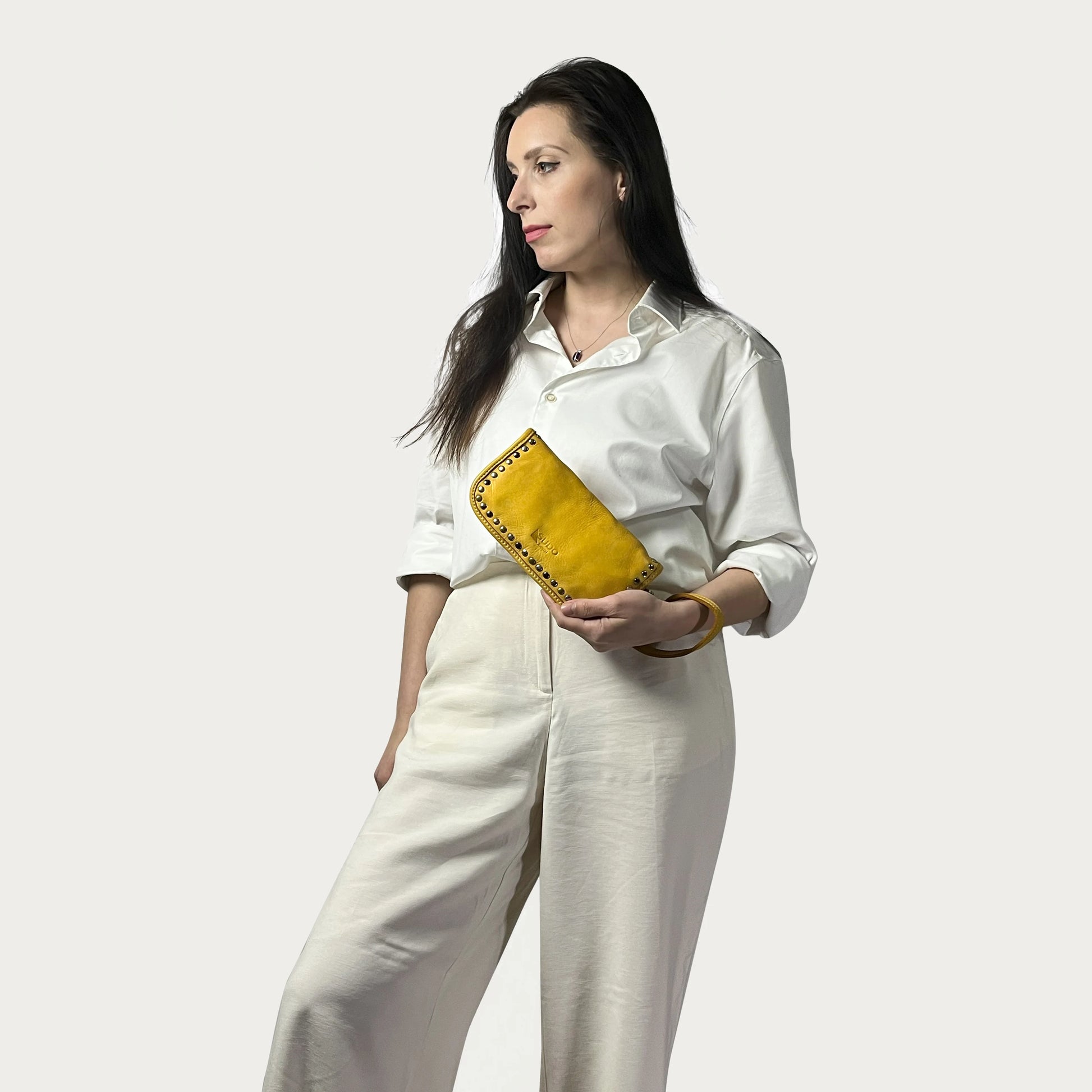Mustard Italian leather wallet — Aurum style — carried by model — Made in Tuscany