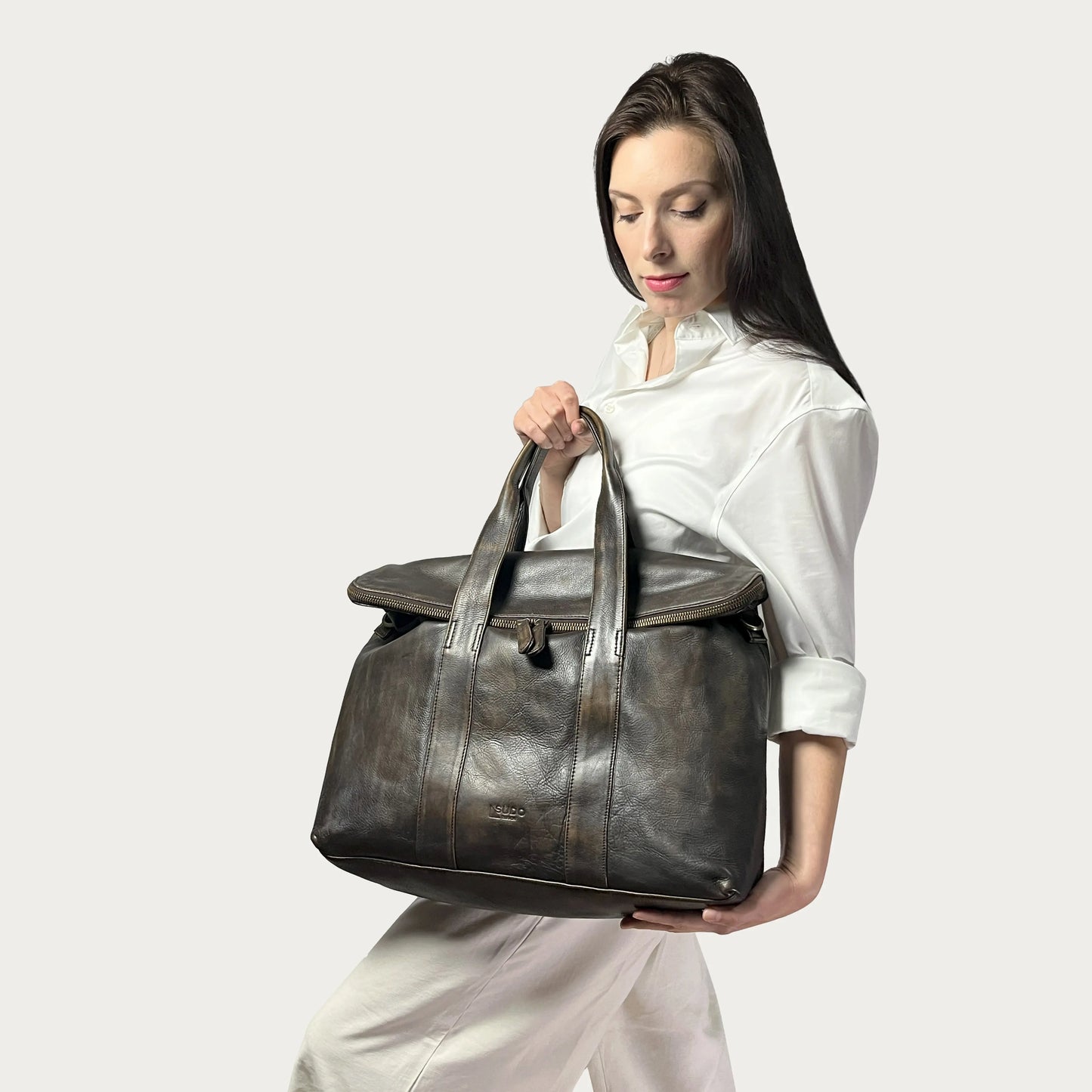Brown Italian leather handbag — Journey style — carried by model — Made in Tuscany