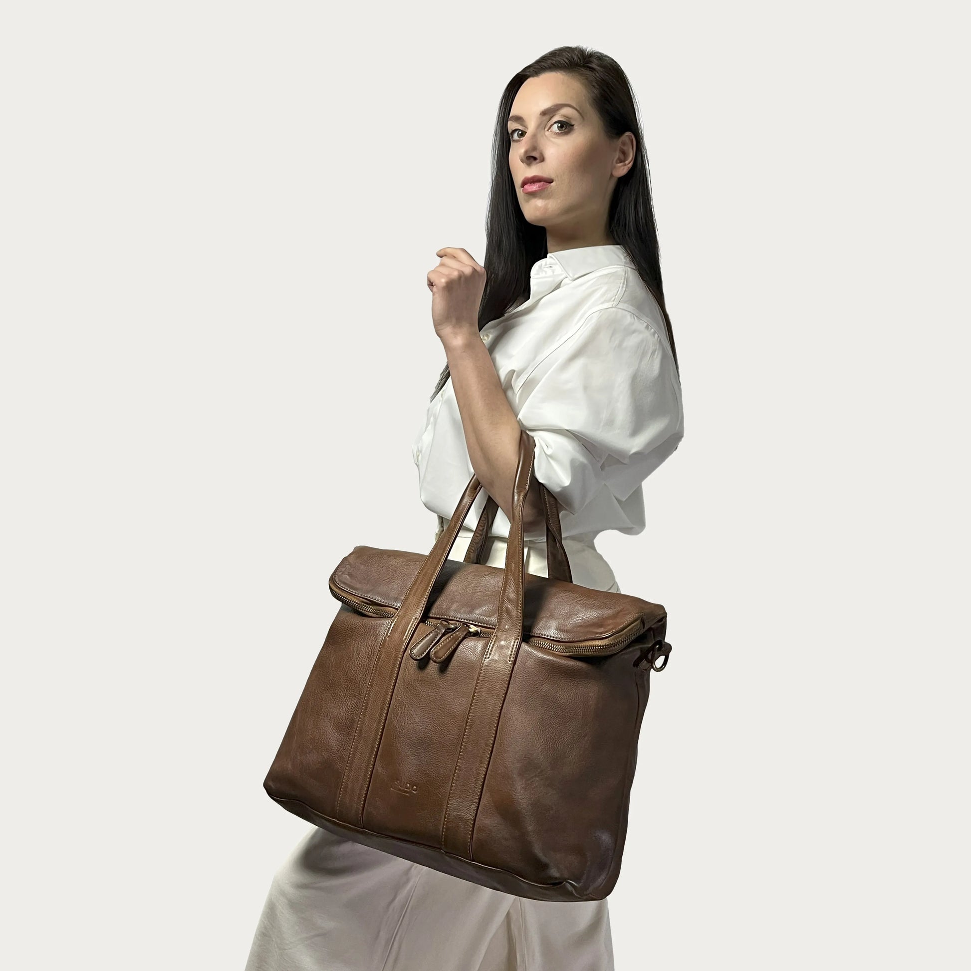 Cognac Italian leather handbag — Journey style — carried by model — Made in Tuscany