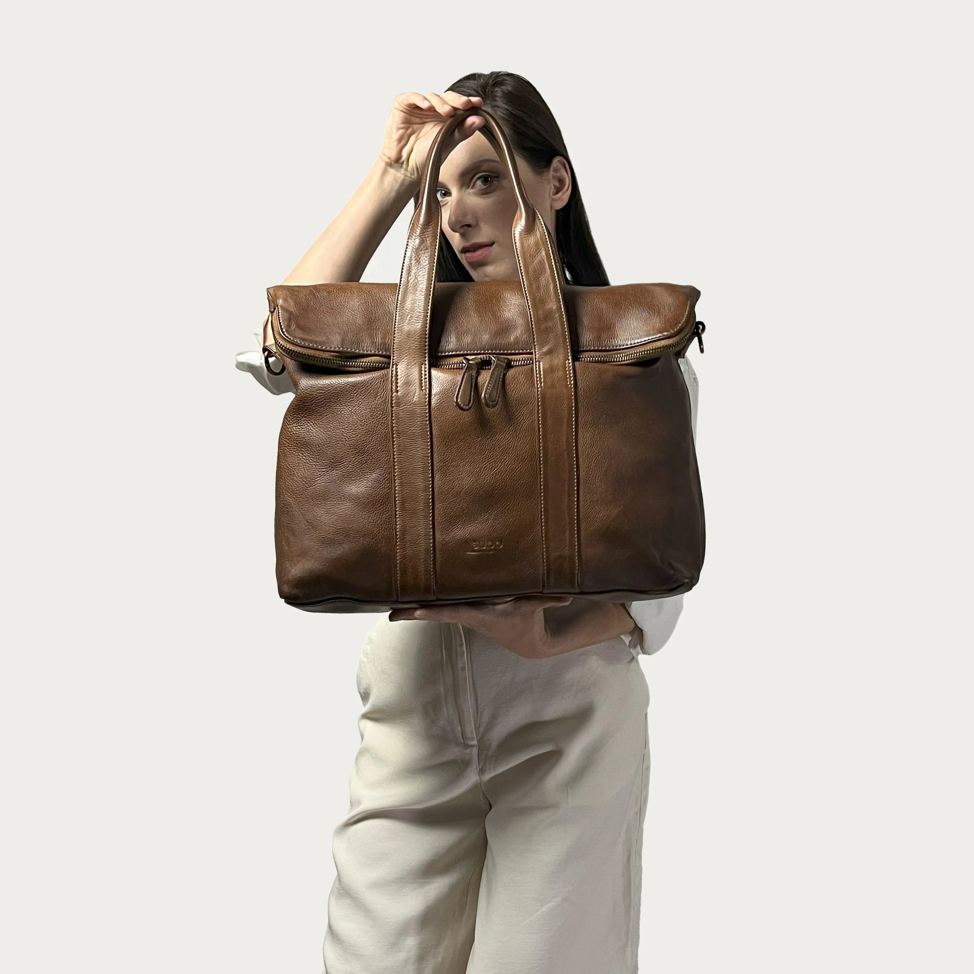 Cognac Italian leather handbag — Journey style — carried by model — Made in Tuscany