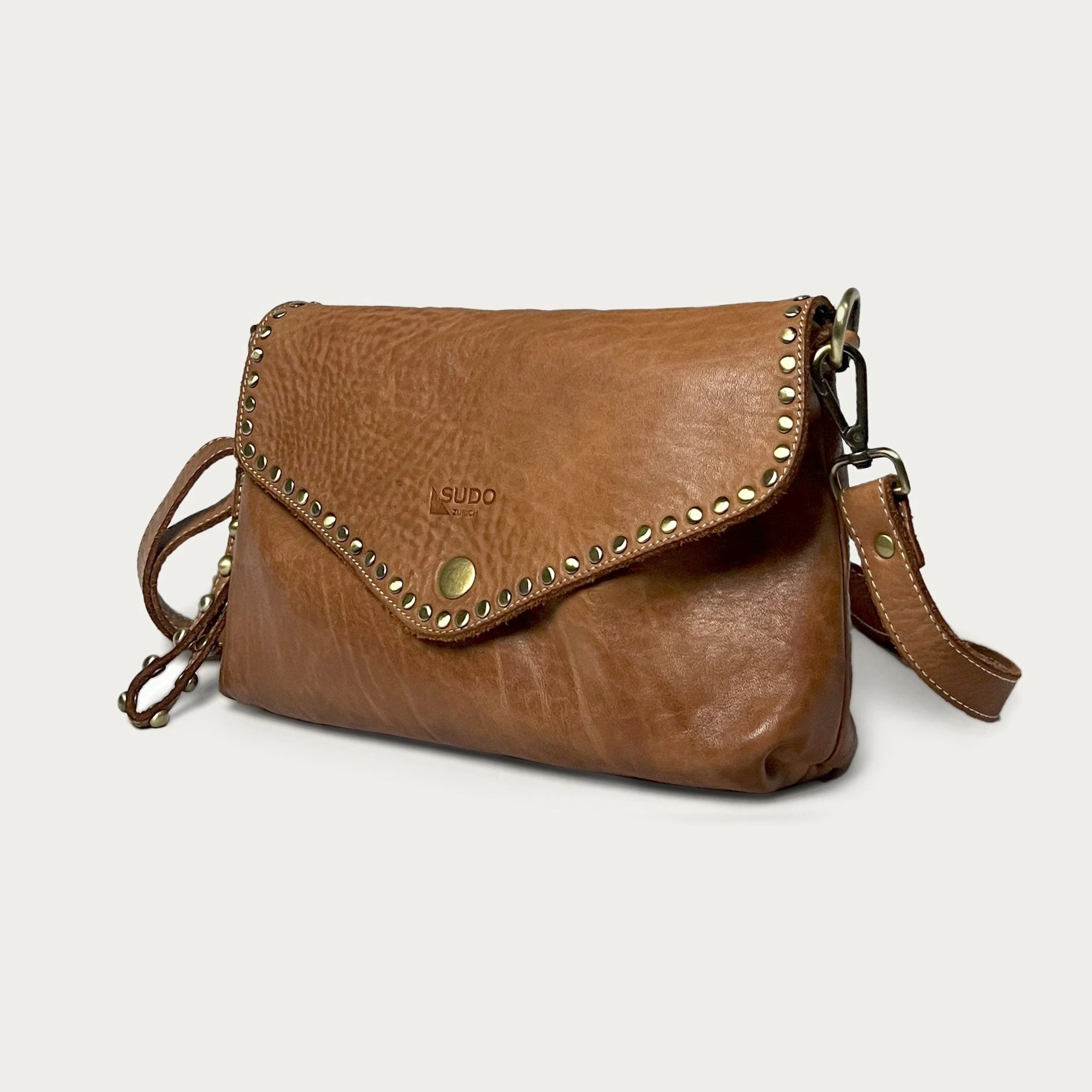 Cognac Italian leather pochette — Solstice style — angled view — Made in Tuscany