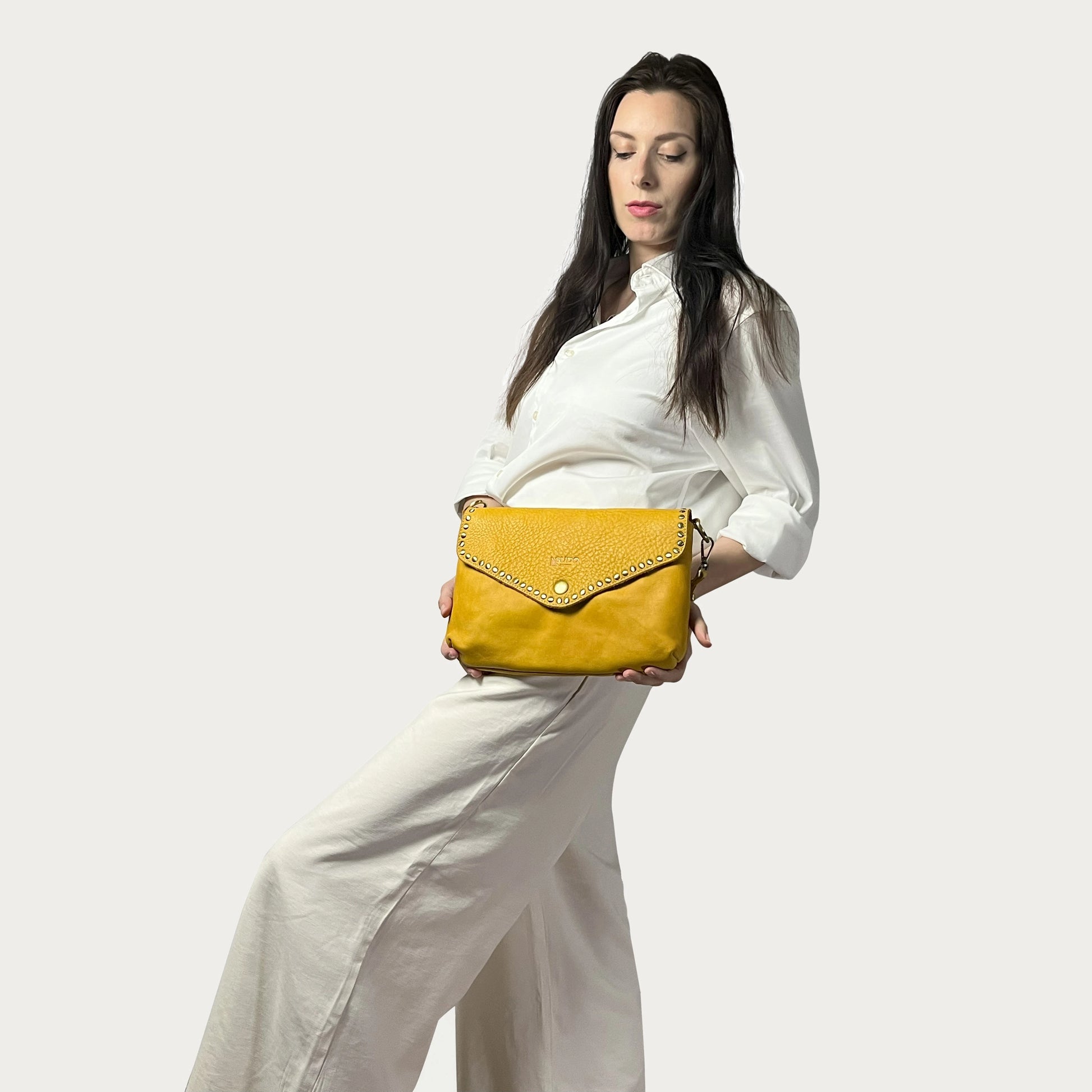 Mustard Italian leather pochette — Solstice style — carried by model — Made in Tuscany