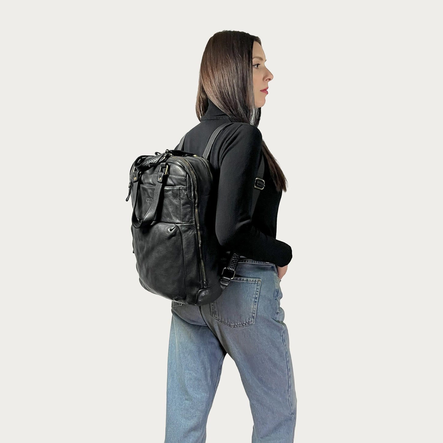 Black Italian leather backpack — Voyage style — carried by model — Made in Tuscany