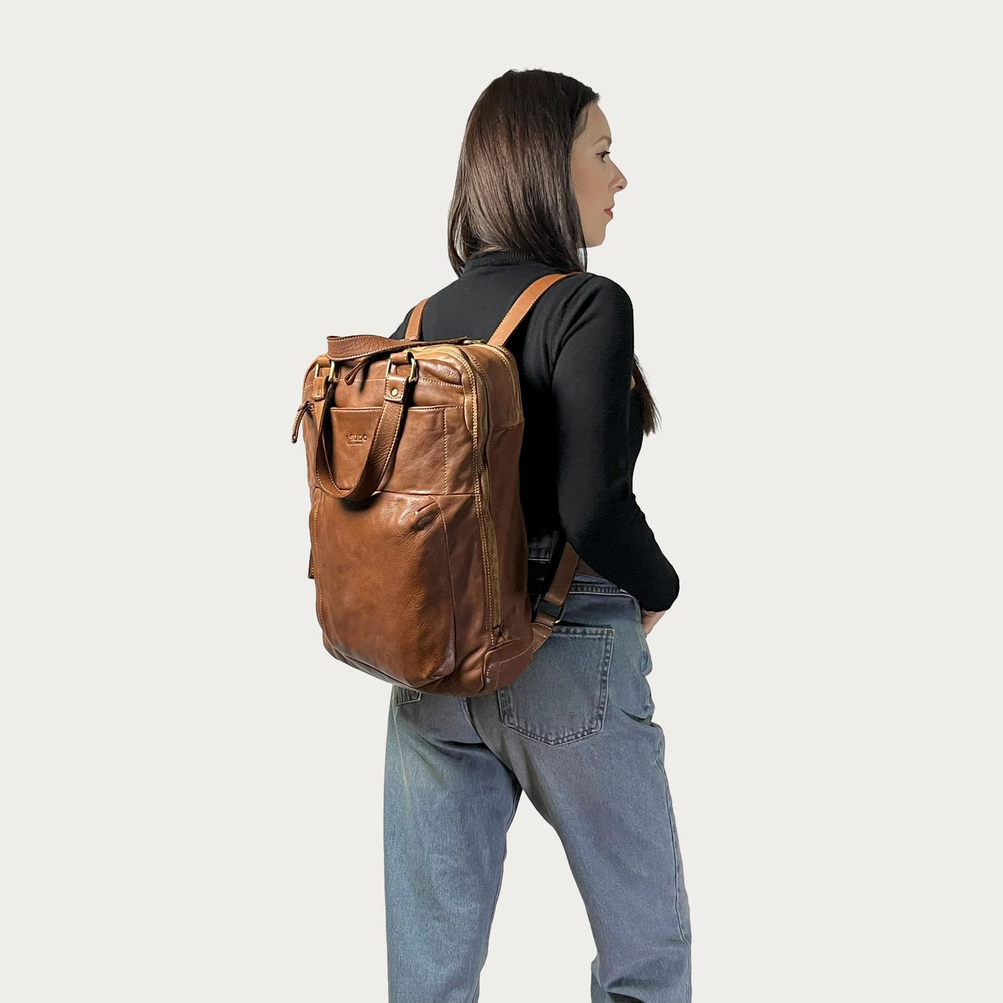 Cognac Italian leather backpack — Voyage style — carried by model — Made in Tuscany