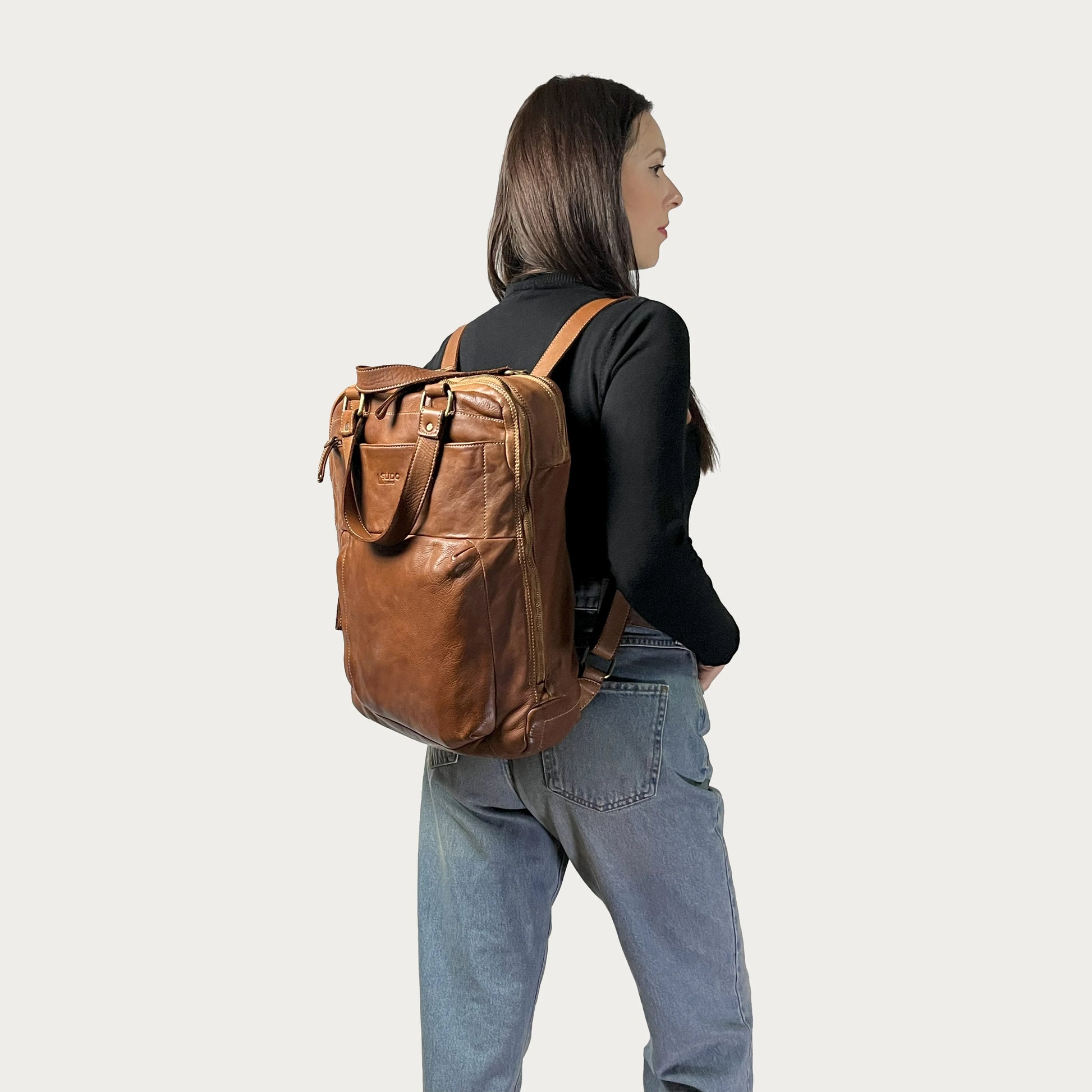 Cognac Italian leather backpack — Voyage style — carried by model — Made in Tuscany