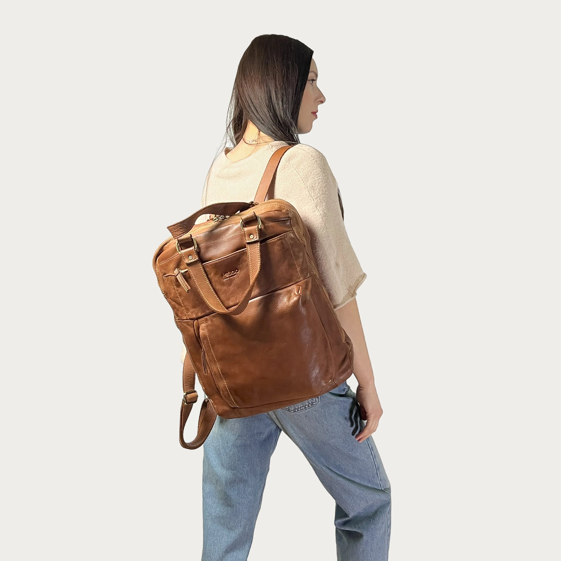 Cognac Italian leather backpack — Voyage style — carried by model — Made in Tuscany