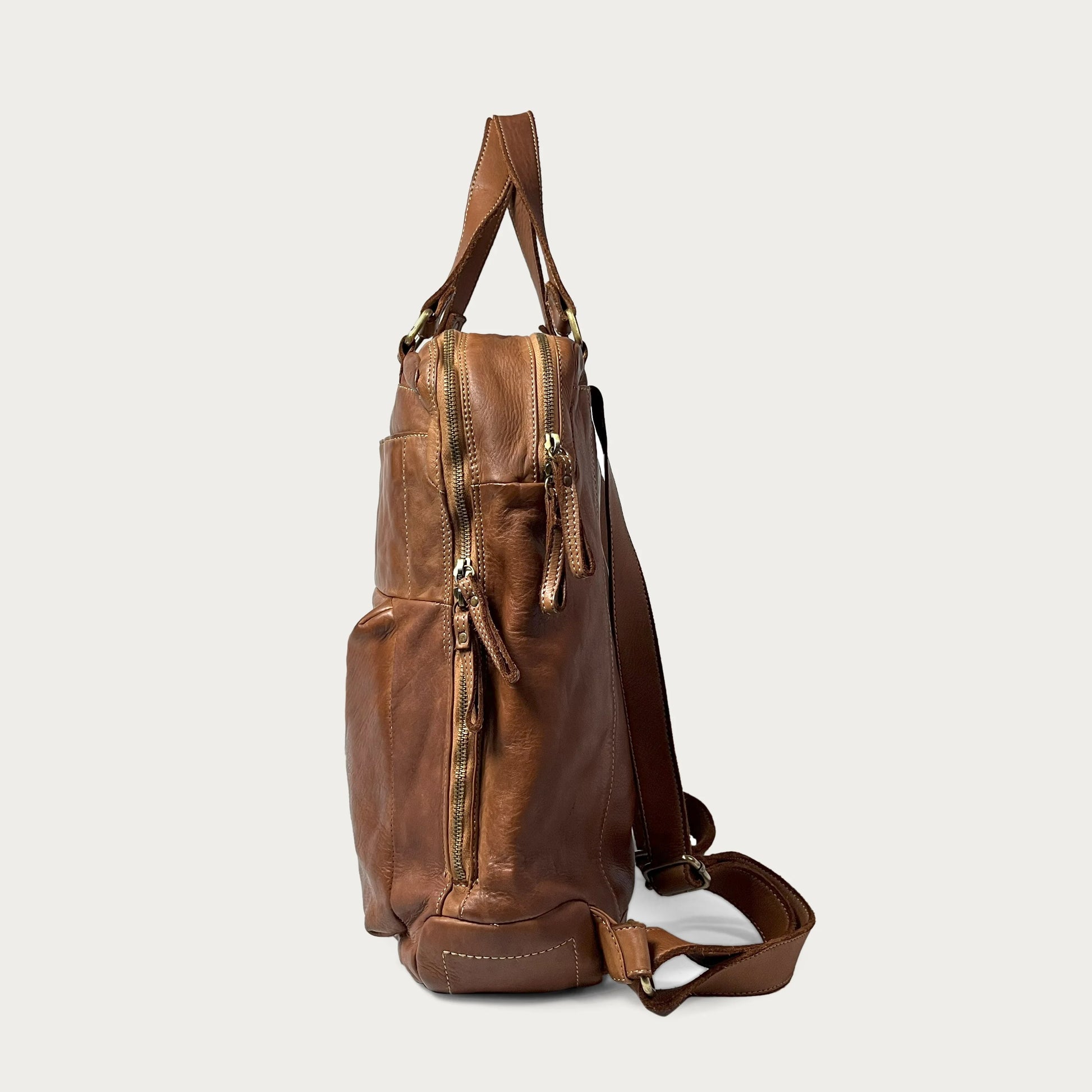 Cognac Italian leather backpack — Voyage style — side view — Made in Tuscany