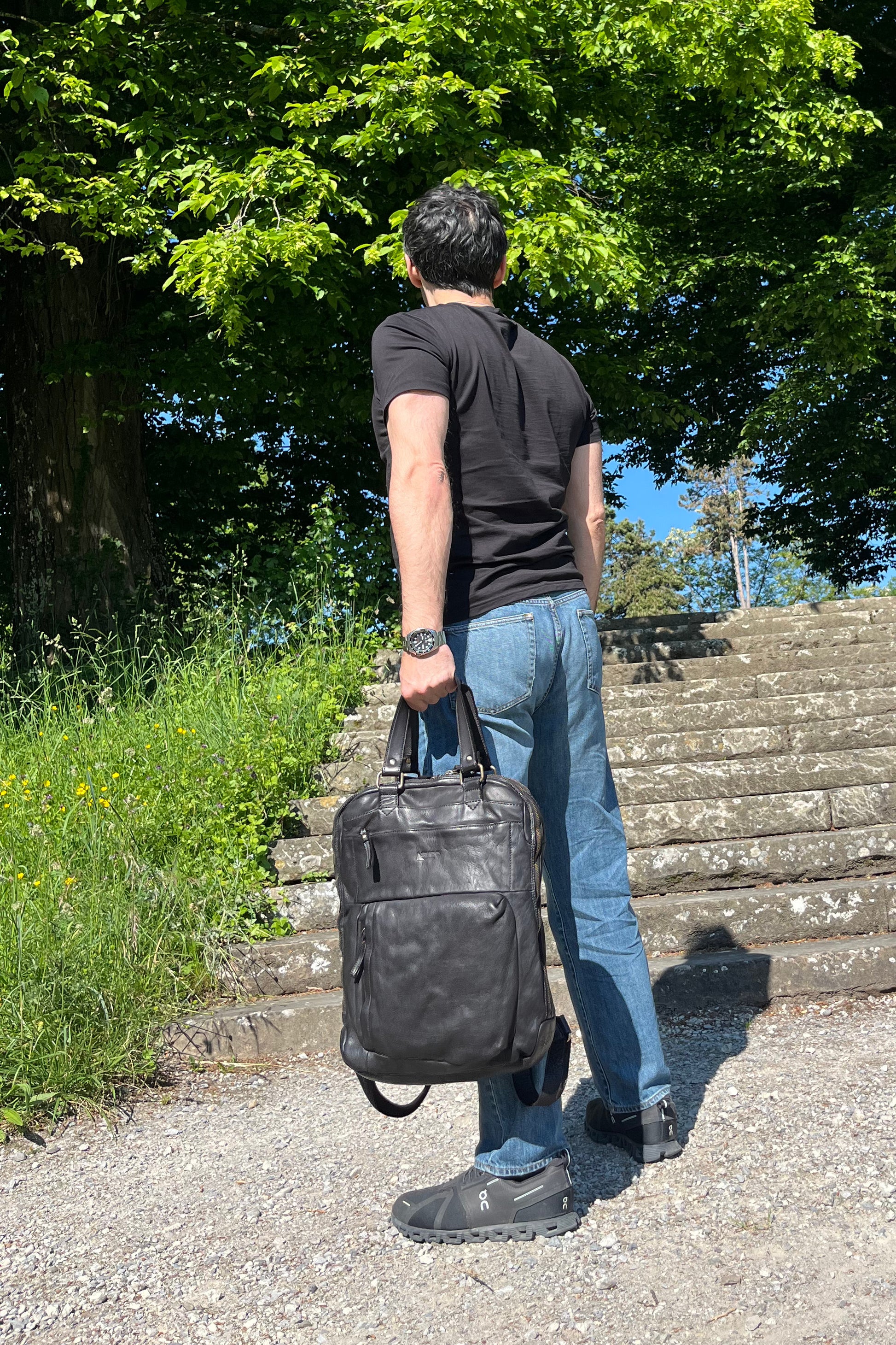 Black Italian leather backpack — Voyage style — lifestyle styling — Made in Tuscany