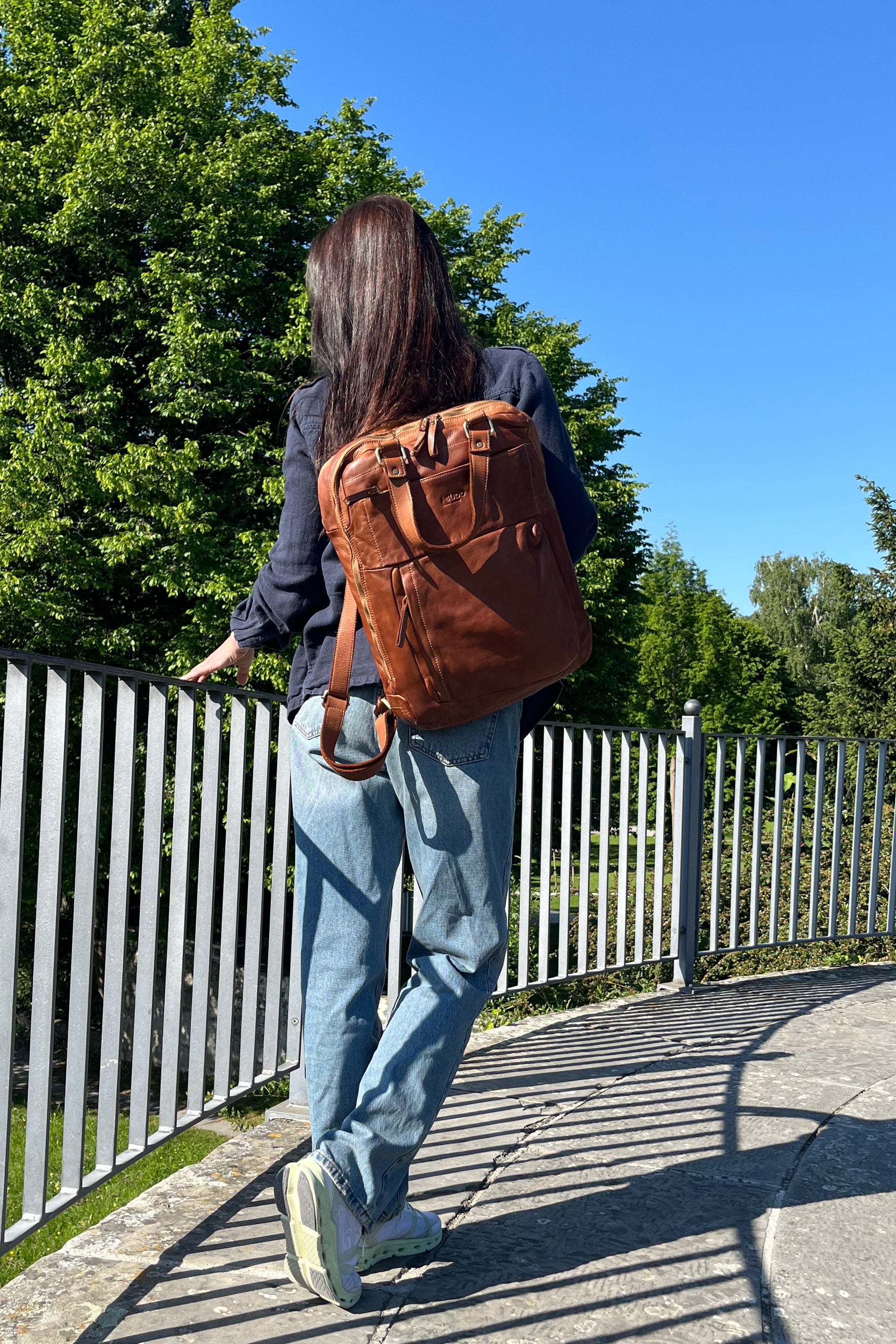 Cognac Italian leather backpack — Voyage style — lifestyle styling — Made in Tuscany