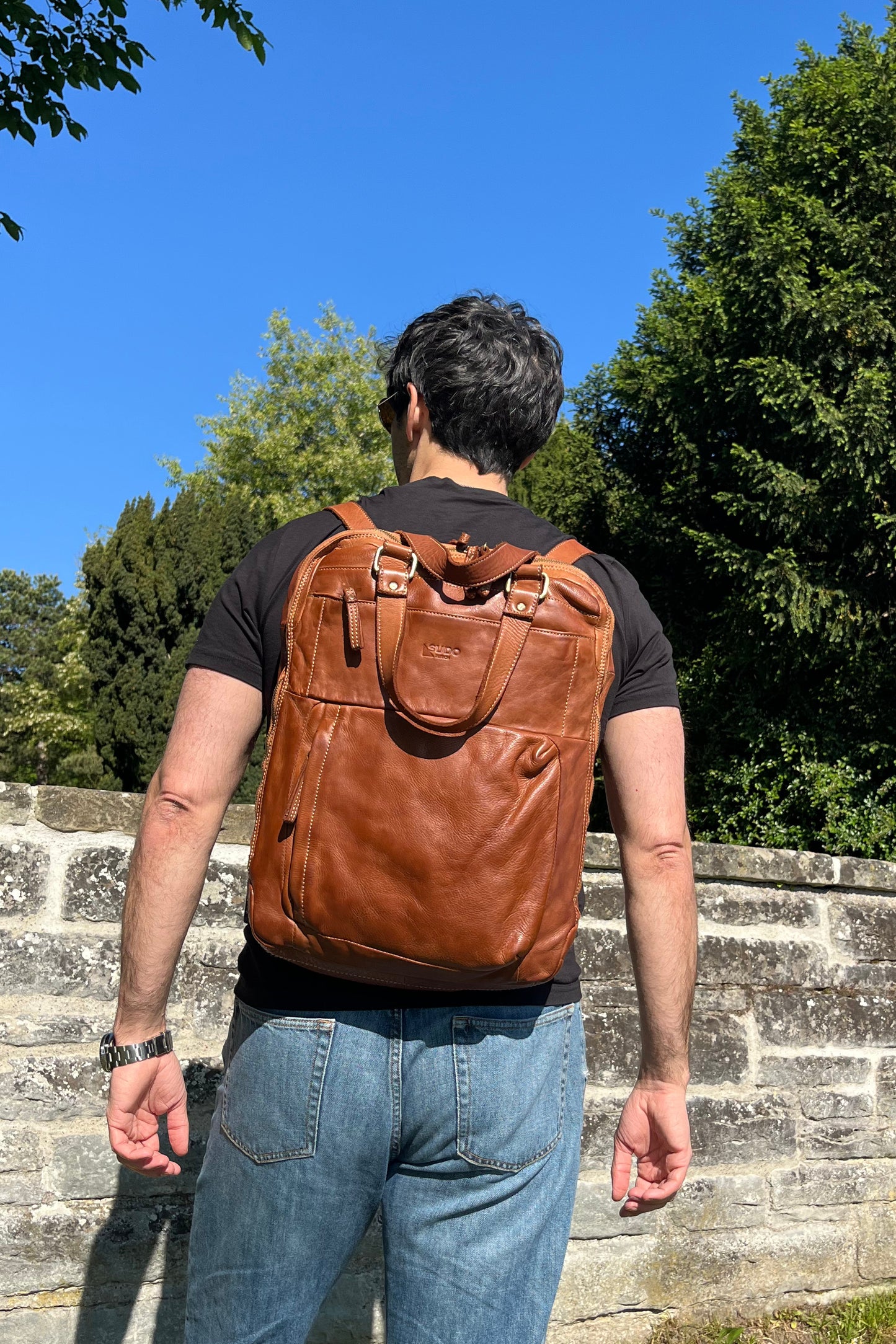 Cognac Italian leather backpack — Voyage style — lifestyle styling — Made in Tuscany